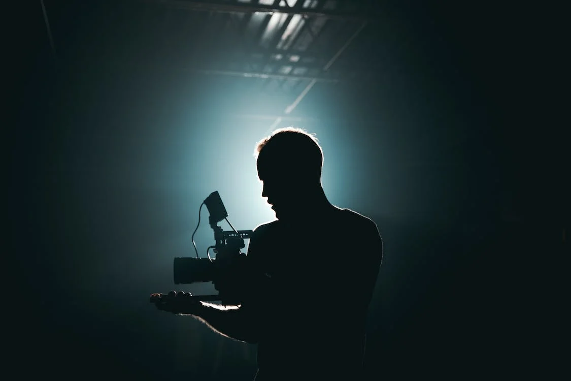 man filming in the dark